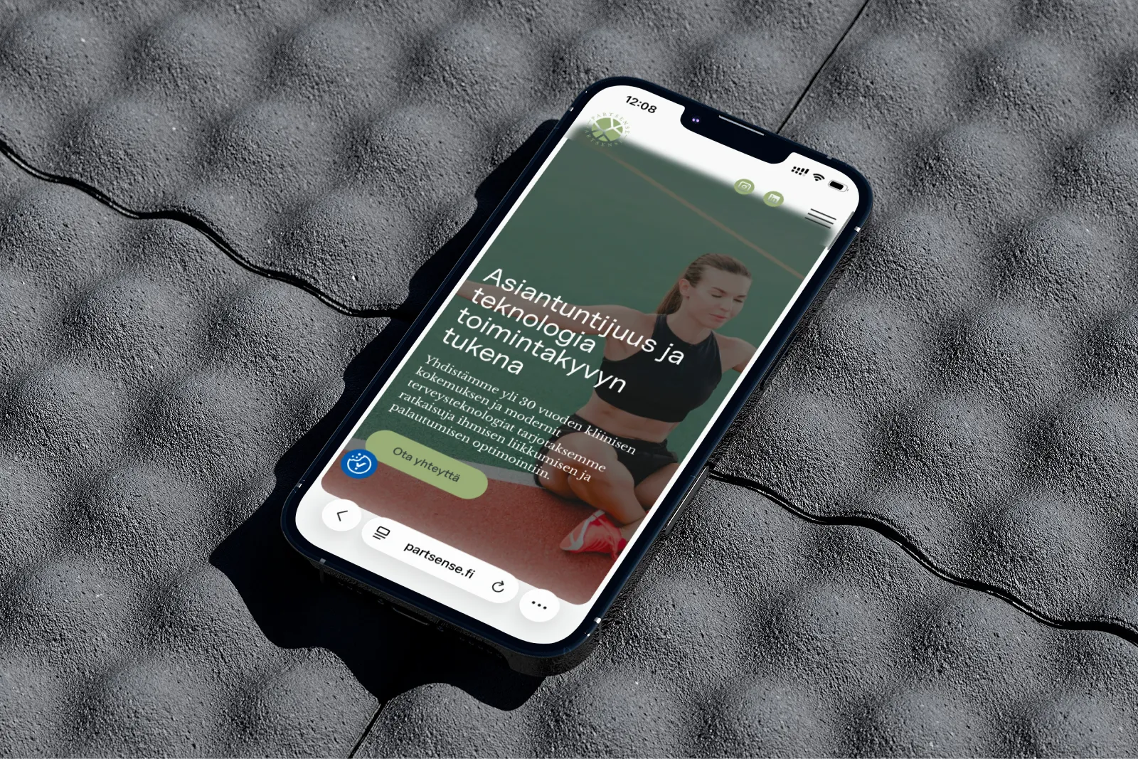 Puhelin, jossa näkyy Partsense Oy:n verkkosivusto, vihreällä taustalla, jossa on varjoja.